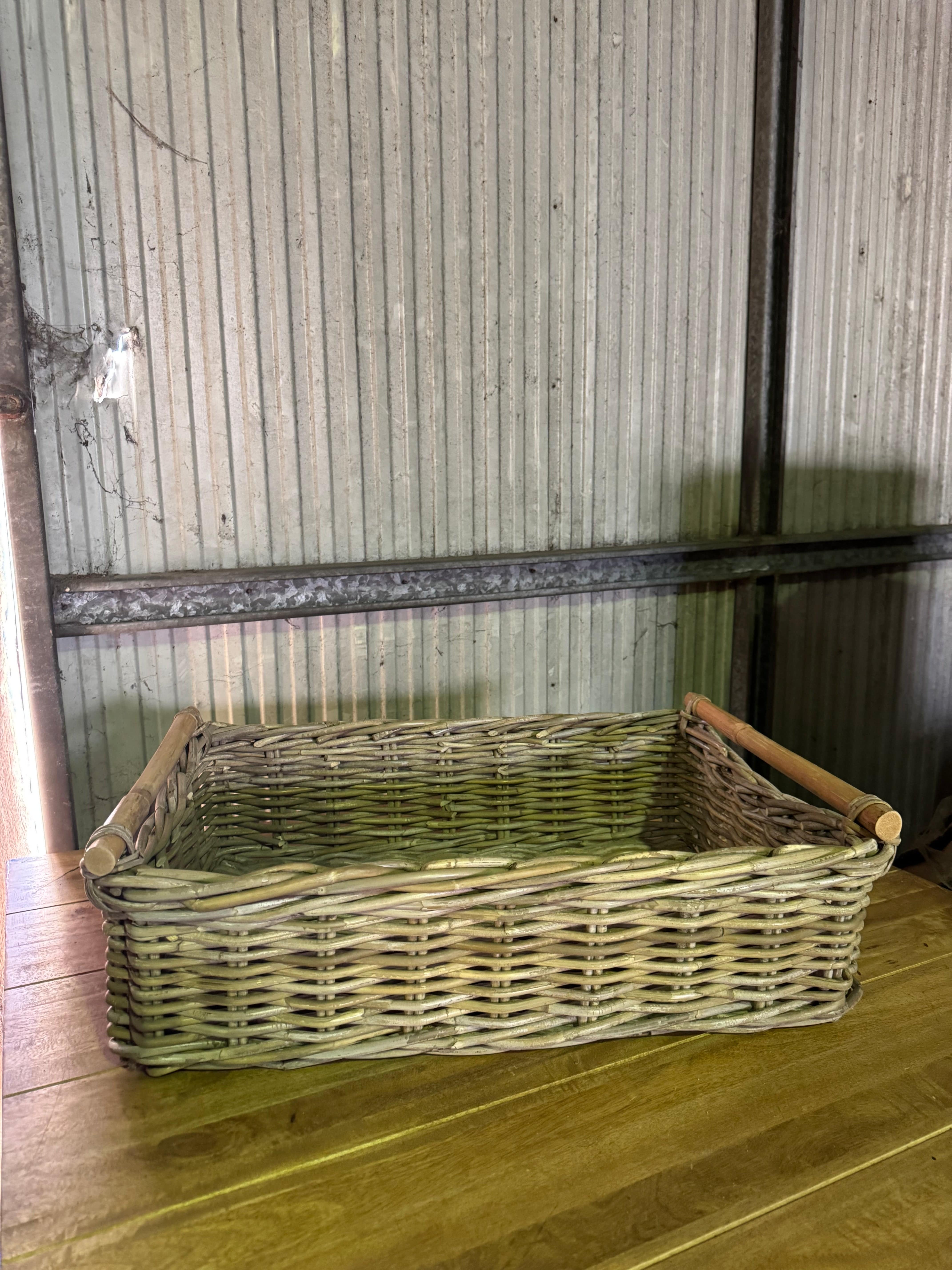Large Kubu Rect Tray displayed on table, featuring handwoven basketware ideal for organizing or displaying home items.