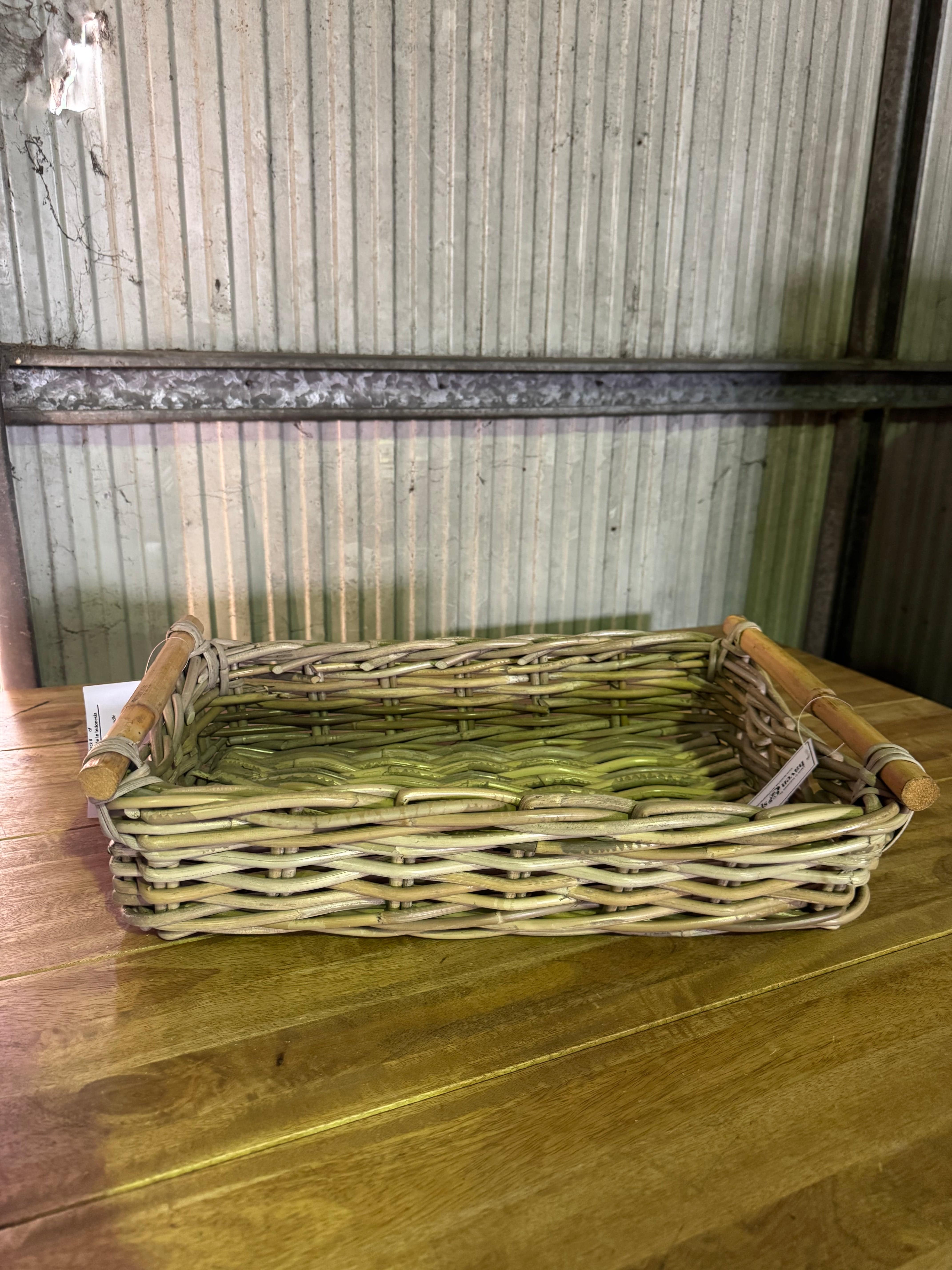 Single Kubu Rect Tray on wooden surface, showcasing woven rattan texture and bamboo-style handles for elegant home decor.