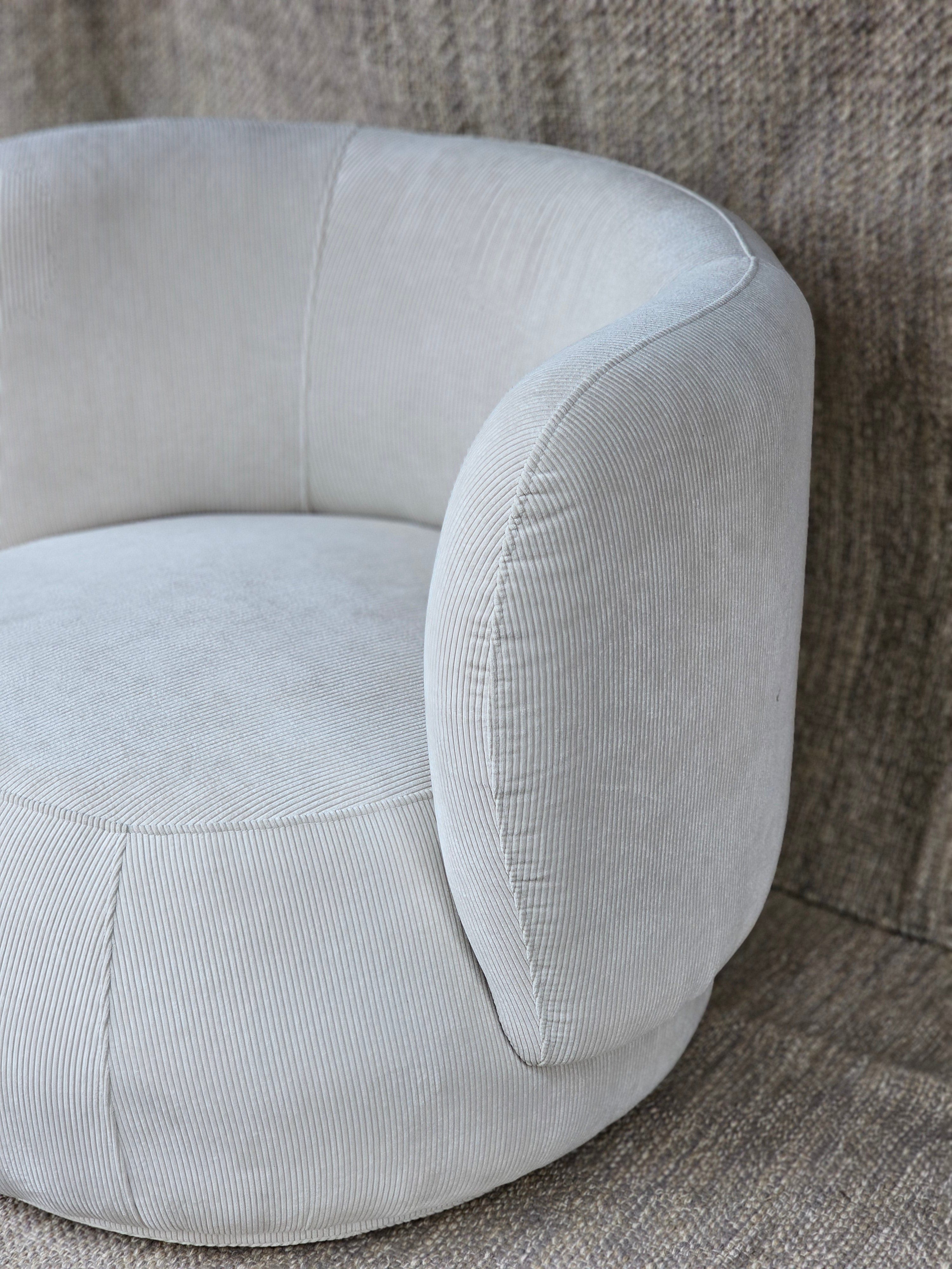 Angled view of Luna Swivel Armchair featuring plush padding and soft corduroy texture, ideal for stylish and functional seating.