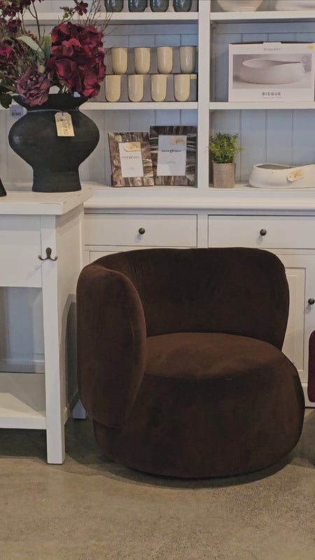 Luxurious Mila Swivel Armchair featuring plush brown upholstery and rounded design, ideal for cozy living room or lounge spaces.