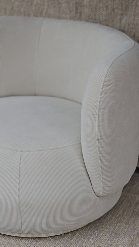 Close-up of Luna Swivel Armchair showcasing curved armrest and textured upholstery, perfect for cozy and stylish interiors.