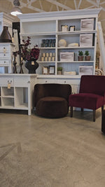 Mila Swivel Armchair showcased in a home decor store, surrounded by modern furniture and accessories, emphasizing its stylish appeal.