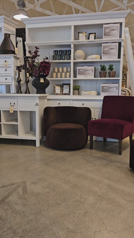 Mila Swivel Armchair showcased in a home decor store, surrounded by modern furniture and accessories, emphasizing its stylish appeal.