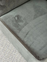 Close-up of the Omega Upholstered Armchair seat cushion in grey fabric, showing plush comfort and high-quality upholstery.